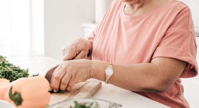 elderly lady cutting vegetables