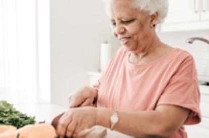 elderly lady cutting vegetables